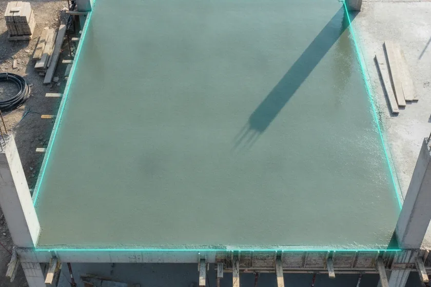 AI segmentation mask over a poured concrete floor slab on a construction site