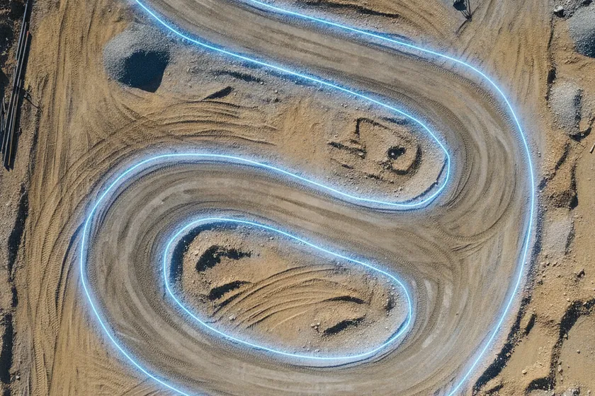 AI segmentation mask over a haul-road vehicle tracks on a construction site
